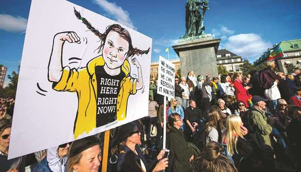 An activist holds up placard depicting 16-year-old Swedish climate activist Greta Thunberg during a demonstration in Stockholm yesterday.