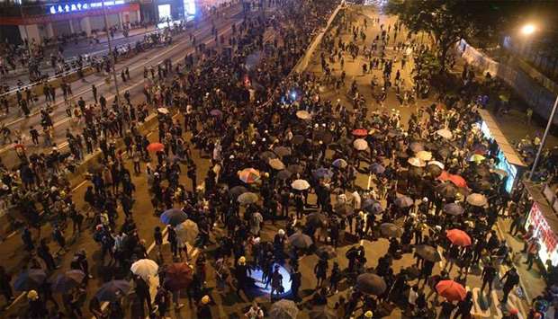 Protesters occupy a main road outside the central government offices (R) in the Admiralty area in Hong Kong