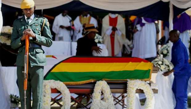Soldier stands over the coffin of former Zimbabwean President Robert Mugabe during a church service at his rural village in Kutama, Zimbabwe