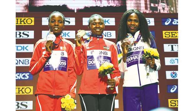 Gold medallist Kenyau2019s Ruth Chepngetich (centre), silver medallist Bruneiu2019s Rose Chelimo and bronze medallist Namibiau2019s Helalia Johannes (right) on the womenu2019s marathon podium at the Khalifa International Stadium in Doha yesterday. (Reuters)