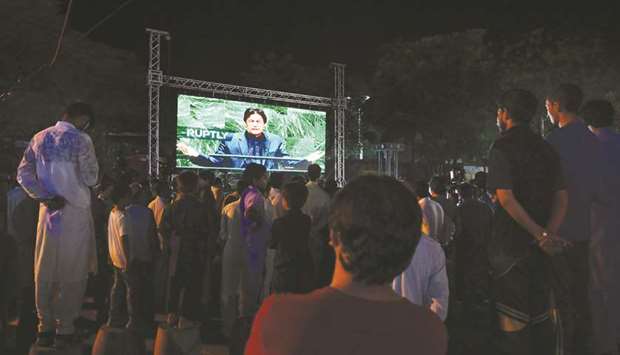 This picture taken on Friday evening shows people in Islamabad watching Prime Minister Khan addressing the United Nations General Assembly.