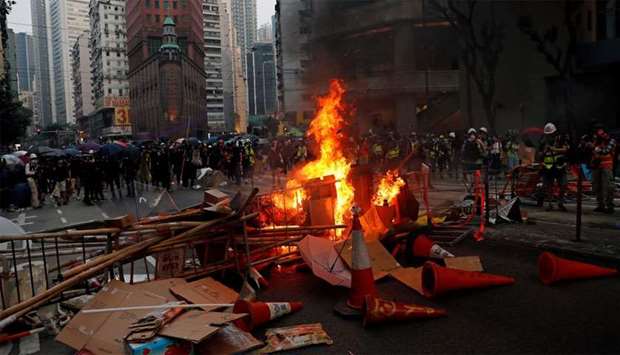Anti-government protesters set barricades on fire after a clash with riot police in Hong Kong