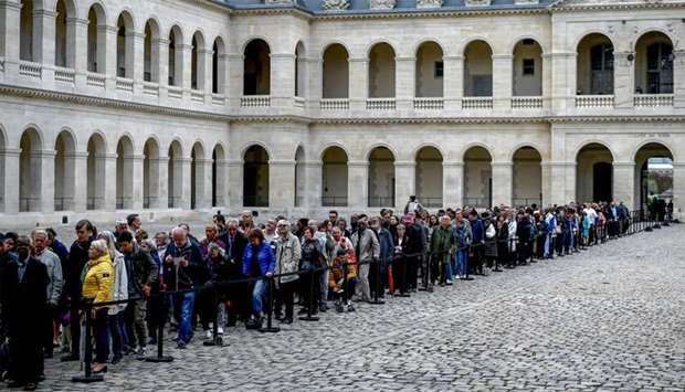 People queue to say a final farewell to former French President Jacques Chirac as the coffin lie in state at the Saint-Louis-des-Invalides cathedral at the Invalides memorial complex in central Paris