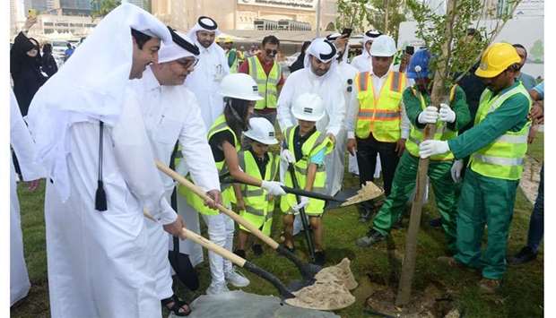 Officials and schoolchildren take part in a tree-planting exercise. PICTURE: Shemeer Rasheed