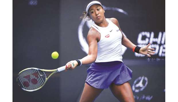Naomi Osaka hits a return against Jessica Pegula in their first round match at the WTA China Open in Beijing, China, yesterday. (AFP)