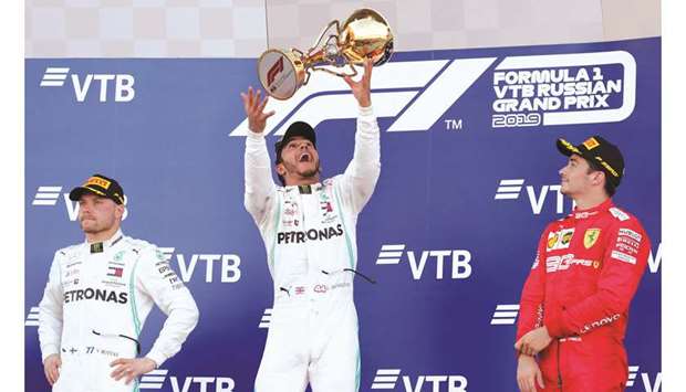 Mercedesu2019 Lewis Hamilton (centre) celebrates with the trophy after winning the Russian Grand Prix alongside runner-up Mercedesu2019 Valtteri Bottas (left) and  third-placed Ferrariu2019s Charles Leclerc at the Sochi Autodrom in Sochi, Russia, yesterday. (Reuters)
