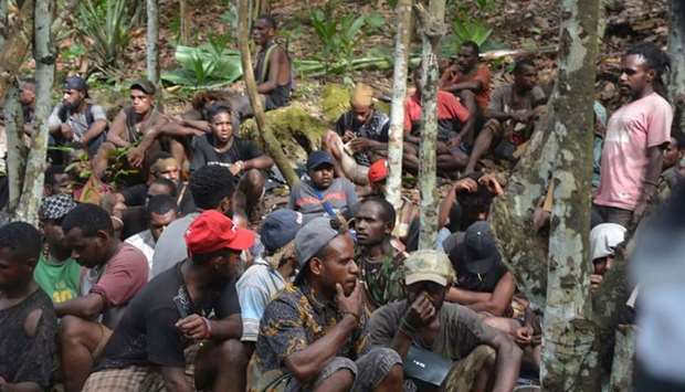 A group of Papuans, who took part in recent mass protests and currently seeking military's help to return to their homes, in Jayapura. AFP/Indonesian Military