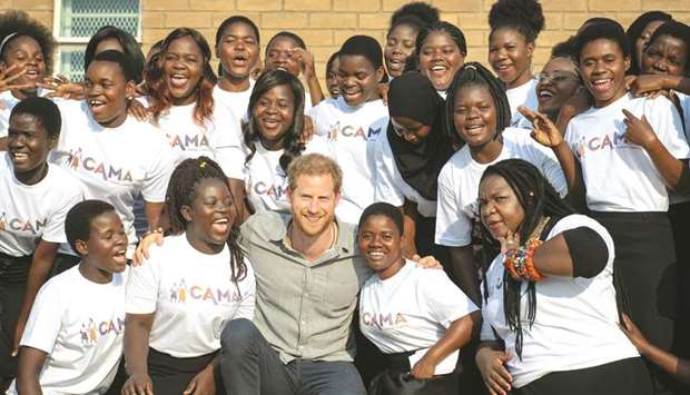 Prince Harry, Duke of Sussex, poses with the Cama choir during his visit to the Nalikule College of Education to learn about the Cama network and how it is supporting young women, in Lilongwe, Malawi, yesterday.
