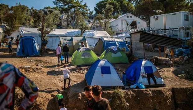 Refugees and migrants gather at Moria camp on the island of Lesbos