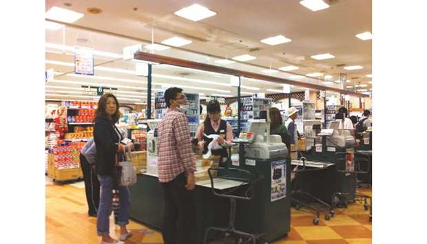 Shoppers at a supermarket in Tokyo. After postponing the sales tax hike twice already, Prime Minister Shinzo Abe is going ahead with it to show Japan is serious about chipping away at the  developed worldu2019s largest public debt load, and to keep up with spiralling social security costs as the population ages.