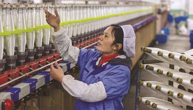 An employee works at a textile factory in Wuyi in Chinau2019s eastern Zhejiang province. In China, the Caixin/Markit Manufacturing Purchasing Managersu2019 Index (PMI) for August rose to a five-month high of 50.4 from 49.9 in July, beating a median market forecast and exceeding the 50-point level that separates contraction from growth on a monthly basis.