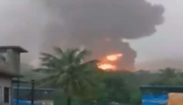 A screenshot from a video posted on social media that shows smoke and fire billowing from the ONGC plant.
