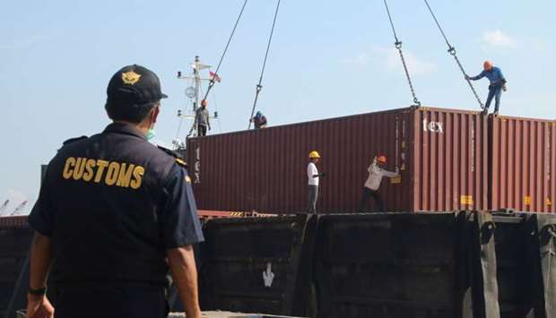 This file photo dated July 29, 2019 shows Indonesian custom officers preparing to return containers filled with hazardous rubbish to their countries of origin, in Batam