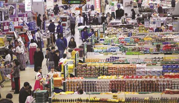 An elevated view shows shoppers and employees at a Hanaro Mart supermarket in Seoul. South Koreau2019s consumer inflation faltered to its slowest on record in August while second quarter economic growth was revised down on weaker exports, firming up the case for central bank rate cuts as early as next month.