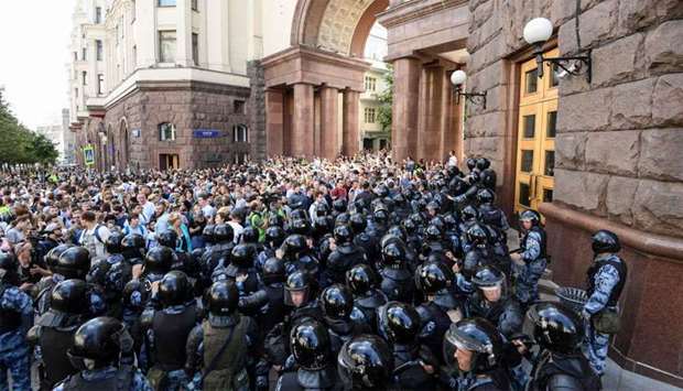 Protesters confront riot police in downtown Moscow