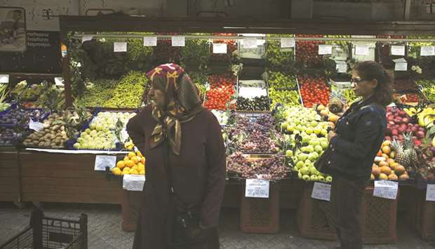 Handwritten price signs sit beside displays of fresh fruit for sale at a market stall in the Gungoren district of Istanbul (file). Apart from a brief rise in July, annual inflation has been generally falling after hitting a 15-year high above 25% last October.