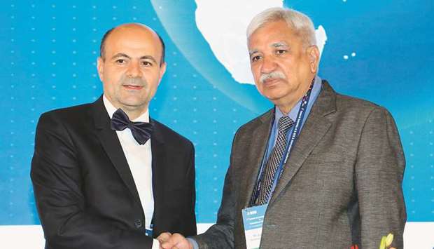 Outgoing chairman of Association of World Election Board (AWEB), Ion Mincu Radulescu (left) shakes hands with his successor Sunil Arora in Bengaluru yesterday.