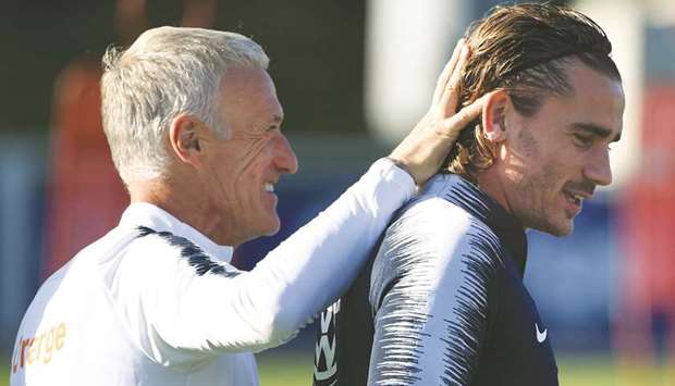 Franceu2019s head coach Didier Deschamps (L) shares a laugh with forward Antoine Griezmann during a training session in Clairefontaine-en-Yvelines as part of the teamu2019s preparations for the upcoming Euro-2020 qualifiers.