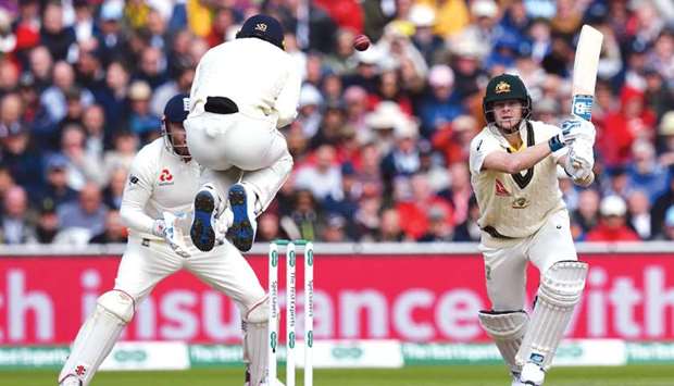 Australiau2019s Steve Smith (right) plays a shot on the first day of the fourth Ashes Test against England at Old Trafford in Manchester, United Kingdom, yesterday. (AFP)