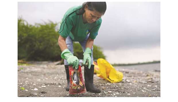 u2018Bakawan warrioru2019 Evangeline Acab, 49, picks up trash from a beach in Freedom Island, Paranaque City.