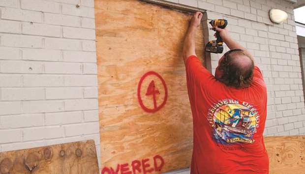 Andrew Tawes boards the door of a kindergarten during a mandatory evacuation for residents as Hurricane Dorian make itu2019s way to Cape Hatteras in North Carolina yesterday.