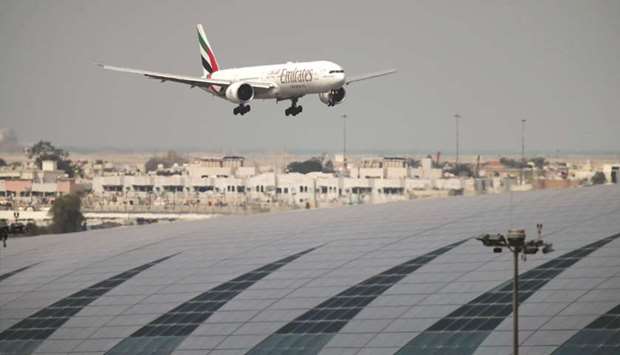 An Emirates Boeing 777-300ER plane lands at the Dubai International Airport. The airline is reviewing its fleet requirement in light of the demise of the Airbus SE A380 jumbo and a deteriorating global economy.