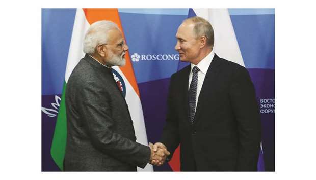 Russian President Vladimir Putin shakes hands with Prime Minister Narendra Modi during a joint press conference in Vladivostok yesterday.