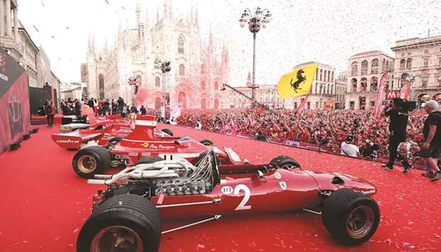 A picture shows a general view of Ferrari racing cars and Ferrari fans in Piazza Duomo in Milan on Wednesday for the presentation of cars and drivers for 90th anniversary of the founding of Scuderia Ferrari. (AFP)