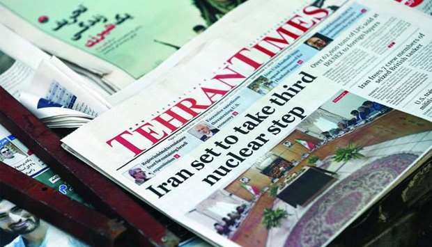 Some newspapers, highlighting the decision to further scale back commitments to the nuclear deal, are pictured in Tehran
