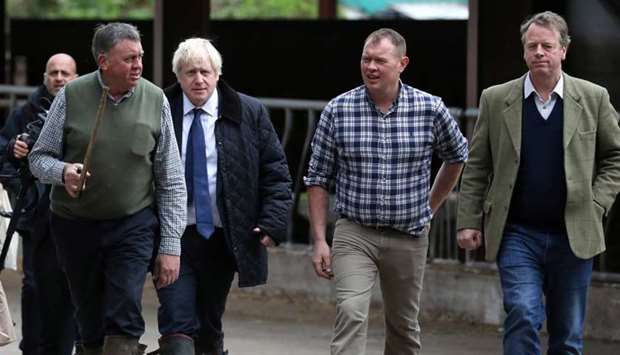 Britain's Prime Minister Boris Johnson, Farmer Peter Watson, David Watson and Scottish Secretary Alister Jack are seen during a visit at Darnford Farm in Darnford, Banchory near Aberdeen, Scotland, Britain