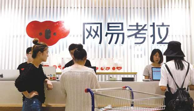 People are seen at the check-out counter of a physical store of NetEaseu2019s e-commerce platform Kaola, in Zhengzhou, Henan province. Alibaba Group has agreed to buy e-commerce business Kaola from Chinese gaming company NetEase for $2bn, adding a platform that specialises in supplying curated luxury goods from abroad to domestic consumers.