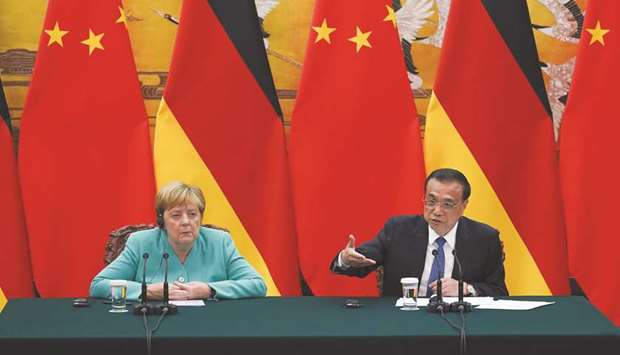 Chinese Premier Li Keqiang (right) speaks during a press conference next to Chancellor of Germany Angela Merkel after their meeting at the Great Hall of the People in Beijing yesterday. Merkel said Germany is open for Chinese investment and she welcomes all Chinese companies to invest in the country.