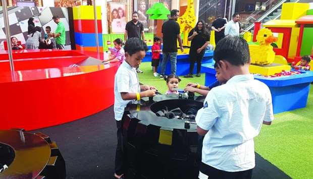 Young visitors try to assemble different objects at the Lego Technic+Architecture zone. PICTURES: Joey Aguilar