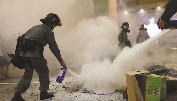 Riot police use fire extinguishers during a demonstration in Mong Kok district in Hong Kong.