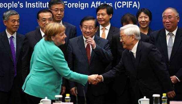 German Chancellor Angela Merkel shakes hands with a guest after the round table of the German-Chinese advised economic committee