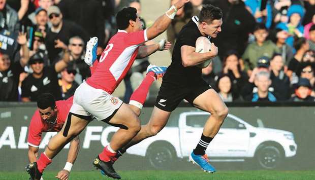 New Zealand George Bridge (right) runs past Tongau2019s Malietoa Hingano during the rugby union Test in Hamilton, New Zealand, yesterday. (AFP)