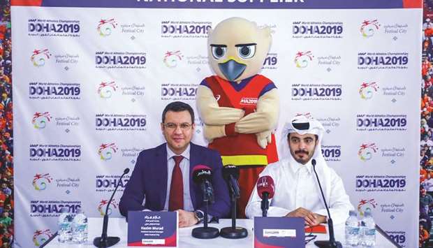 Assistant General Manager of Doha Festival City Hazim Murad (left) and Head Of Sponsorship IAAF World Athletics Championships Abdelhadi al-Marri pose with the championships official mascot Falah.