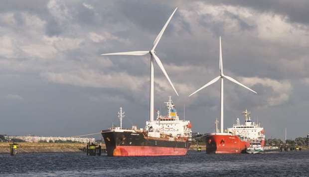 Chemical tankers sit moored near wind turbines at the Port of Rotterdam in Rotterdam, Netherlands on Wednesday. The global shipping industry was initially sceptical about the quality of very-low sulphur fuel oil, but as 2020 approaches market participants agree there is growing confidence in VLSFO.