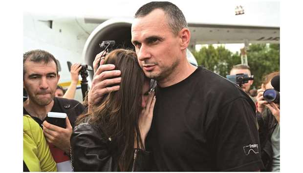 Ukrainian film director Oleg Sentsov hugs his daughter Alina after he disembarked from a plane at Boryspil international airport in Kyiv.