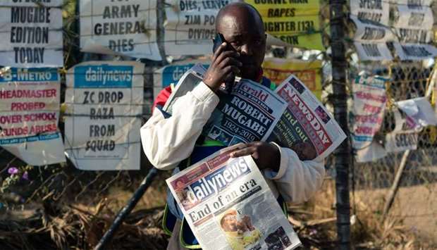 A vendor sells the various daily newspapers on the streets of Harare on the first day of a period of national mourning following the death of former Zimbabwe president Robert Mugabe