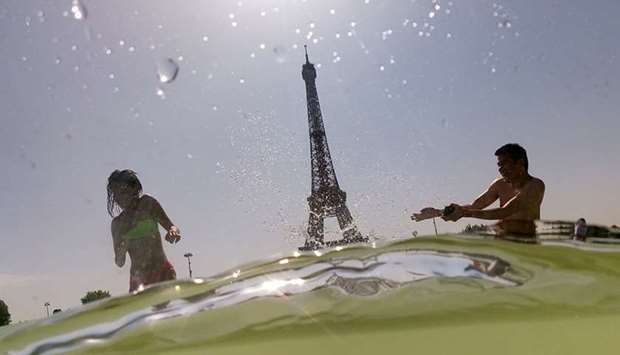 People cool off at the Trocadero Fountains next to the Eiffel Tower in Paris, as a heatwave hits Europe. File photo: July 25, 2019