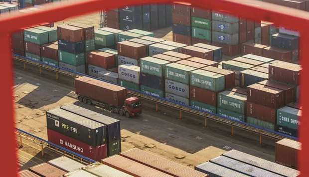 A truck drives past shipping containers at a port in Lianyungang, Jiangsu province. Chinau2019s exports unexpectedly fell in August as shipments to the US slowed sharply, pointing to further weakness in the worldu2019s second-largest economy and underlining a pressing need for more stimulus as the Sino-US trade war escalates.