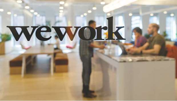 A signage is seen at the entrance of the WeWork offices in the Manhattan borough of New York. The company is in talks with SoftBank Group for more financing that could delay the IPO further and force its valuation far lower than the $47bn it was worth at the beginning of the year, according to sources.