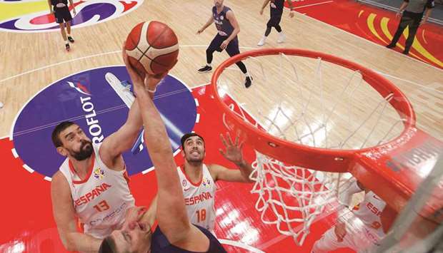 Marc Gasol (left) of Spain is tackled by Nikola Jokic of Serbia as he attempts a shot during their Basketball World Cup Group J second round game in Wuhan yesterday. (AFP)