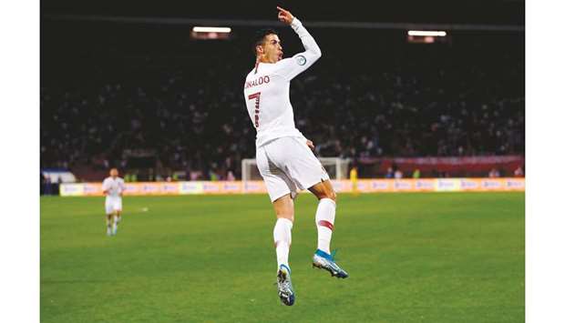 Portugalu2019s forward Cristiano Ronaldo celebrates as after scoring against Serbia in Belgrade.