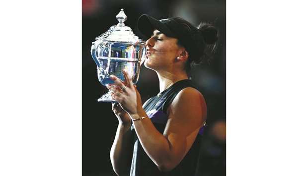 Canadau2019s Bianca Andreescu kisses the US Open trophy after beating Serena Williams of the US in the final on Saturday.