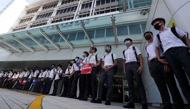 Secondary school students form a human chain as they demonstrate against what they say is police brutality against protesters, after clashes at Wan Chai district, in Hong Kong