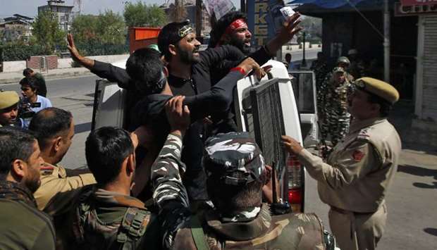 Kashmiri Shia Muslims shout slogans as they are detained by Indian police while trying to participate in a Muharram procession