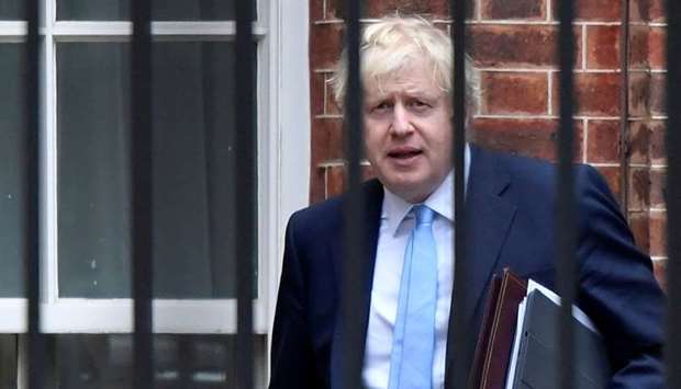 Britain's Prime Minister Boris Johnson leaves Downing Street from the rear entrance door, in London