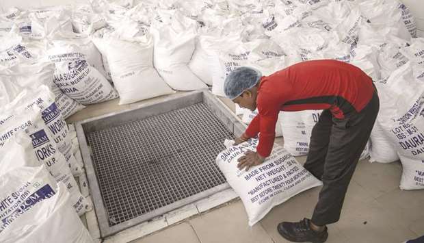 An employee handles a sack of white sugar during the production of Coco-Cola Co drinks at the Moon Beverages Ltd Coca-Cola Happiness Factory in Greater Noida, Uttar Pradesh. India, which often is a swing sugar producer, again takes the spotlight as rivals lambaste the Asian nationu2019s export subsidies.
